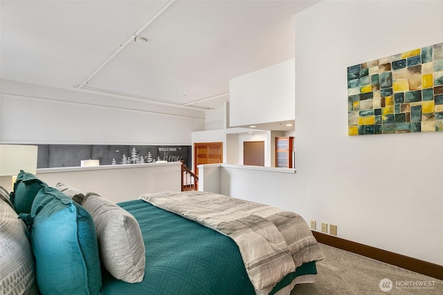 carpeted bedroom featuring baseboards and attic access