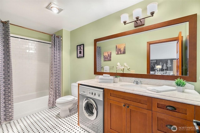 bathroom featuring shower / bath combo with shower curtain, toilet, washer / clothes dryer, and vanity