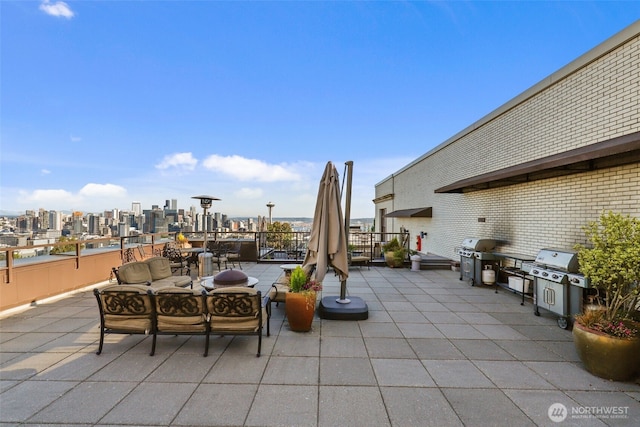 view of patio with a view of city and a grill