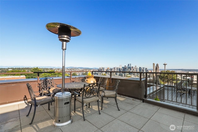 view of patio featuring a view of city and a balcony