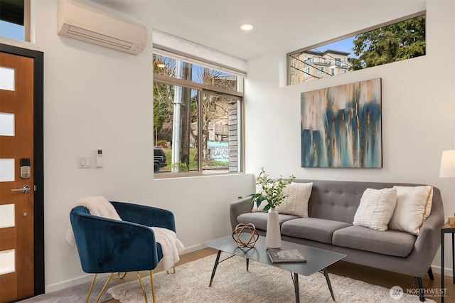 living room featuring recessed lighting, baseboards, and a wall unit AC