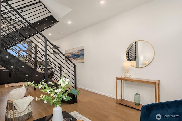 staircase featuring recessed lighting, baseboards, and wood finished floors