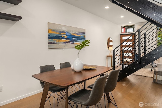 dining space with stairs, recessed lighting, wood finished floors, and baseboards