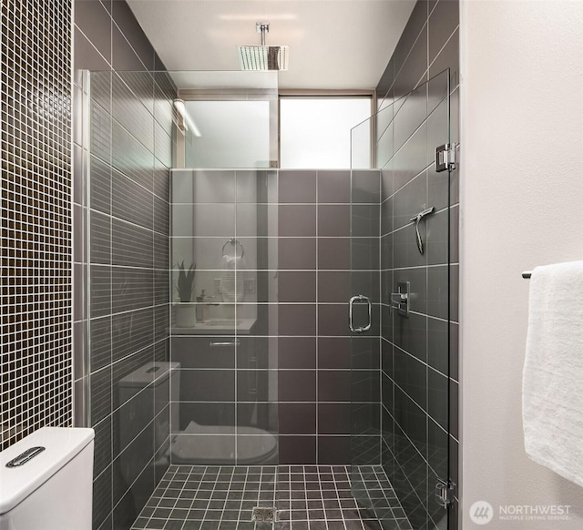 full bathroom with a stall shower and toilet