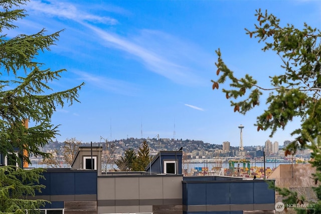 view of patio featuring a water view and a city view