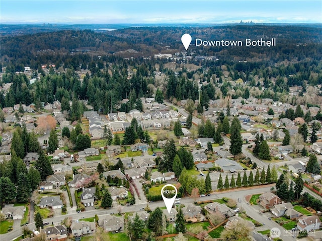 aerial view featuring a wooded view and a residential view