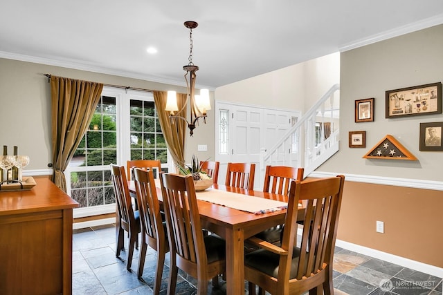 dining room with stone tile flooring, an inviting chandelier, baseboards, and ornamental molding