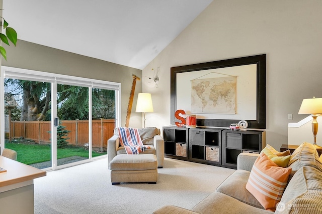 carpeted living area with high vaulted ceiling