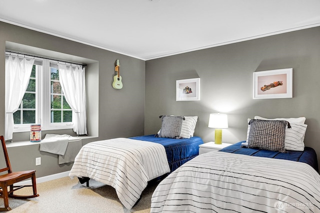 carpeted bedroom featuring baseboards and ornamental molding