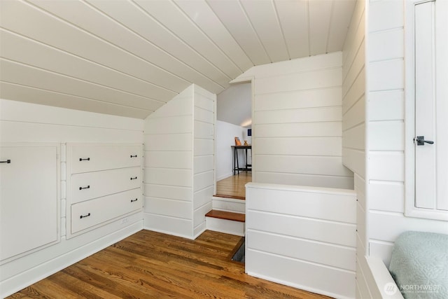 bonus room with dark wood-style floors and lofted ceiling