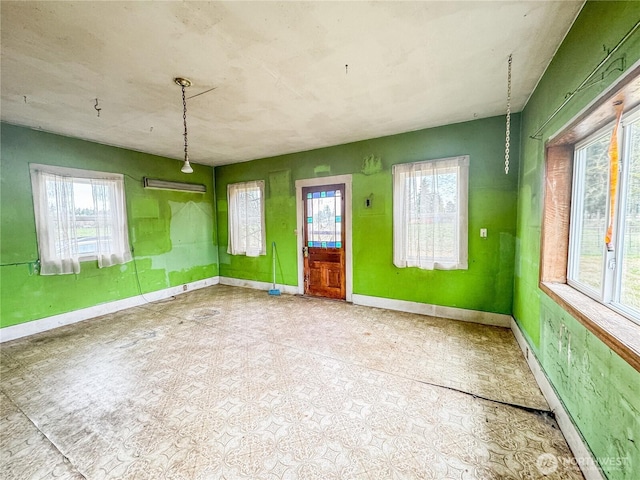 unfurnished room featuring baseboards