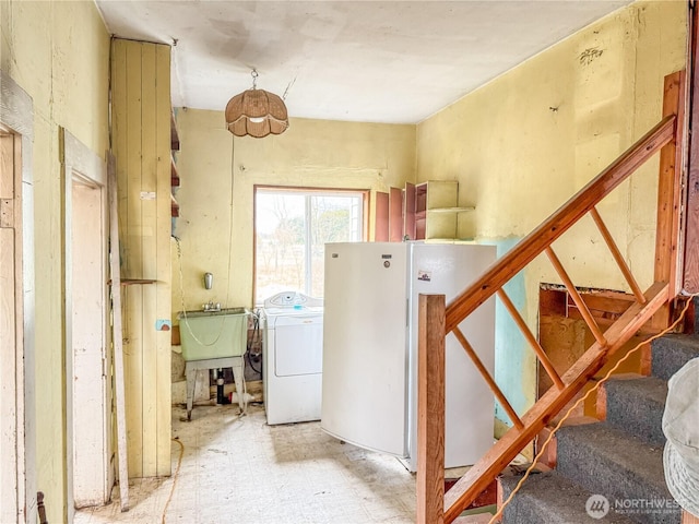 interior space with a sink, washer / dryer, and laundry area