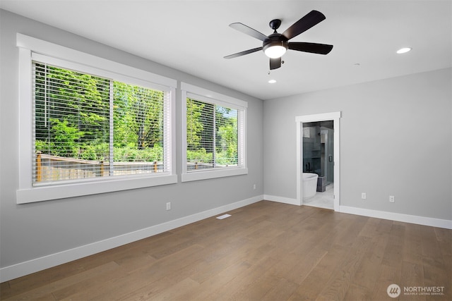 unfurnished room with a ceiling fan, recessed lighting, wood finished floors, and baseboards