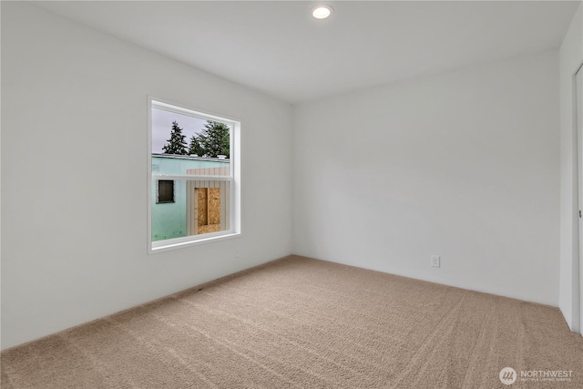 carpeted empty room with recessed lighting