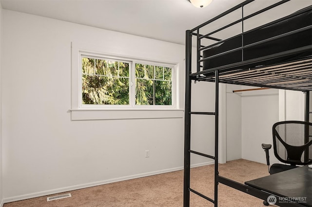 bedroom with carpet, visible vents, and baseboards