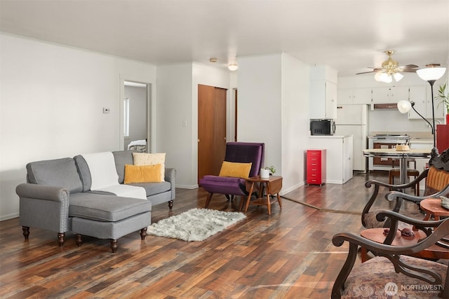 living area with dark wood finished floors, baseboards, and a ceiling fan