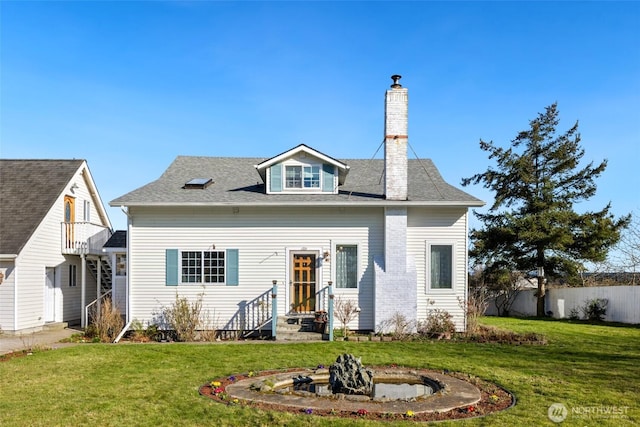 view of front of property featuring a shingled roof, a front yard, fence, and a chimney