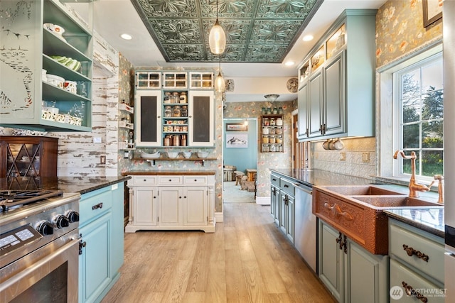 kitchen with light wood-type flooring, open shelves, an ornate ceiling, backsplash, and appliances with stainless steel finishes