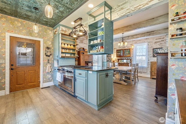 kitchen with light wood-style flooring, high end stainless steel range, open shelves, an ornate ceiling, and wallpapered walls