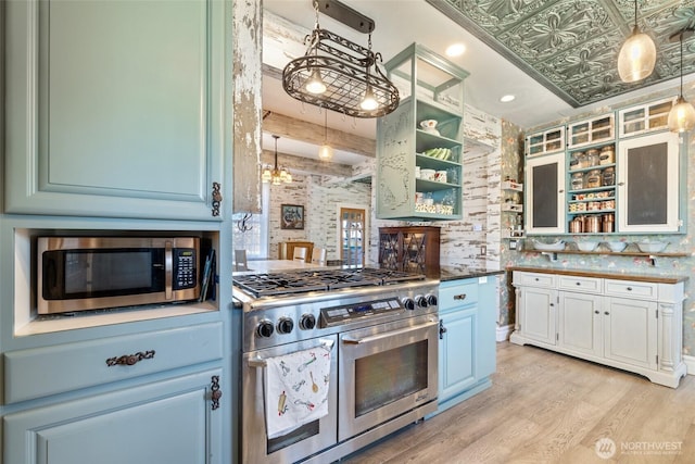 kitchen with open shelves, stainless steel appliances, glass insert cabinets, and light wood finished floors