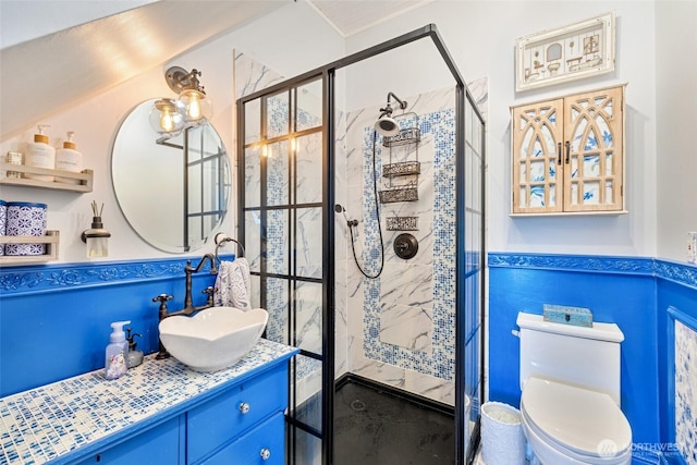 full bath featuring vanity, a shower stall, and toilet