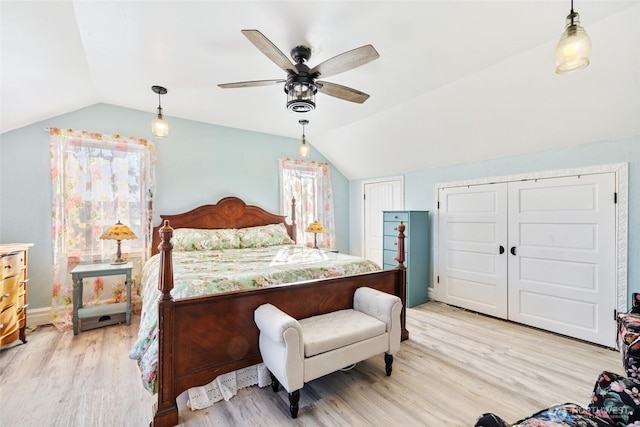 bedroom with light wood-style flooring, lofted ceiling, and ceiling fan