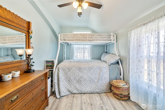 bedroom with lofted ceiling, wood finished floors, and ceiling fan