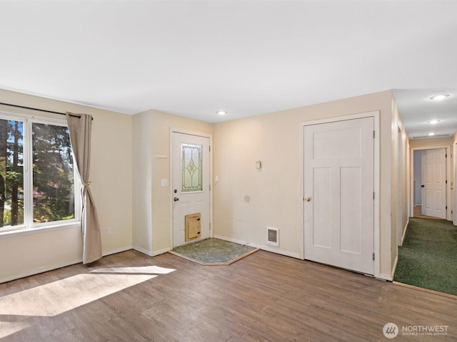foyer with recessed lighting, visible vents, baseboards, and wood finished floors