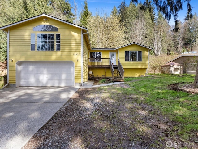 view of front of home with a garage, stairway, and driveway