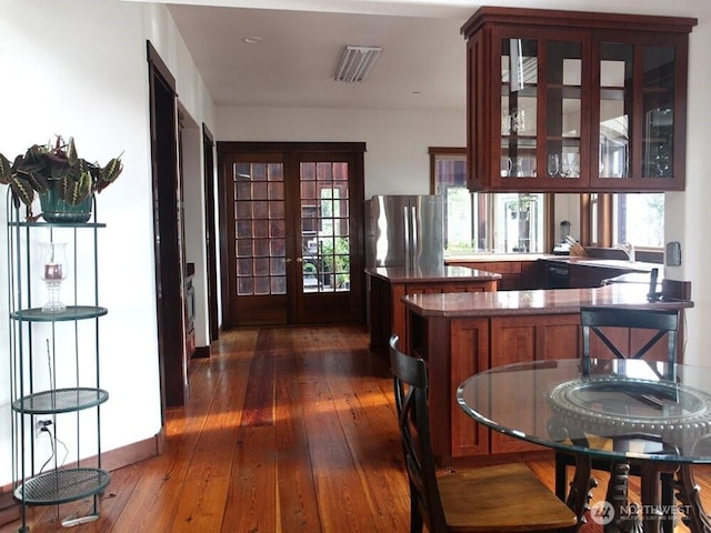 bar with french doors, dark wood-style flooring, and freestanding refrigerator