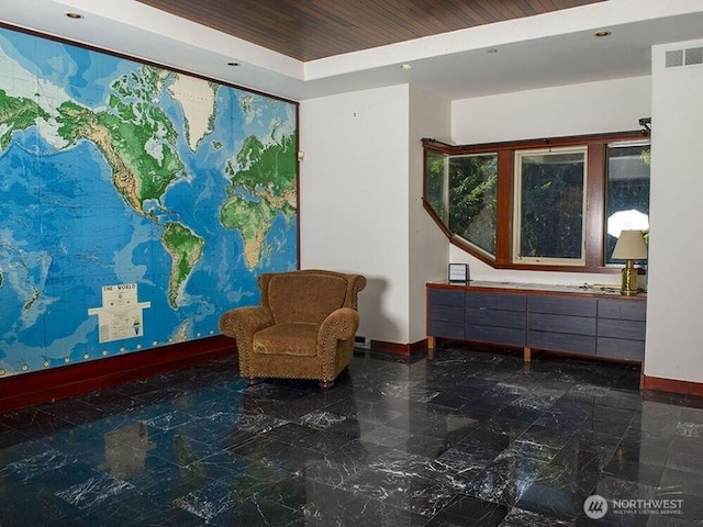 sitting room featuring visible vents, baseboards, wooden ceiling, marble finish floor, and a raised ceiling