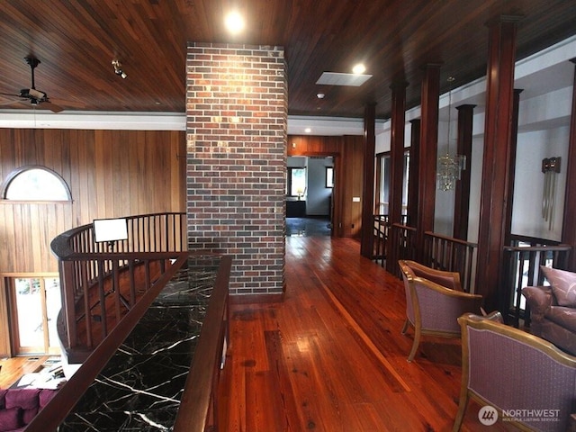 hall with wood ceiling, wood walls, and wood-type flooring