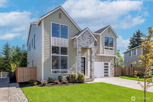 view of front facade with a front yard, fence, a garage, and driveway