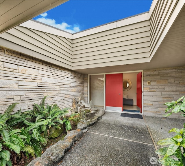 entrance to property with stone siding