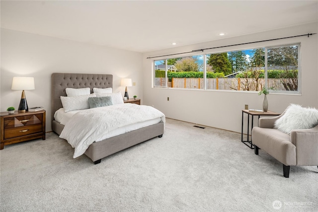 carpeted bedroom featuring visible vents