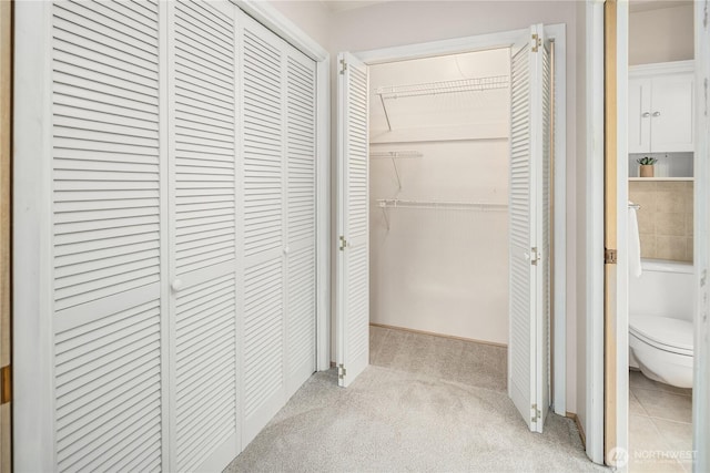 hallway featuring light colored carpet