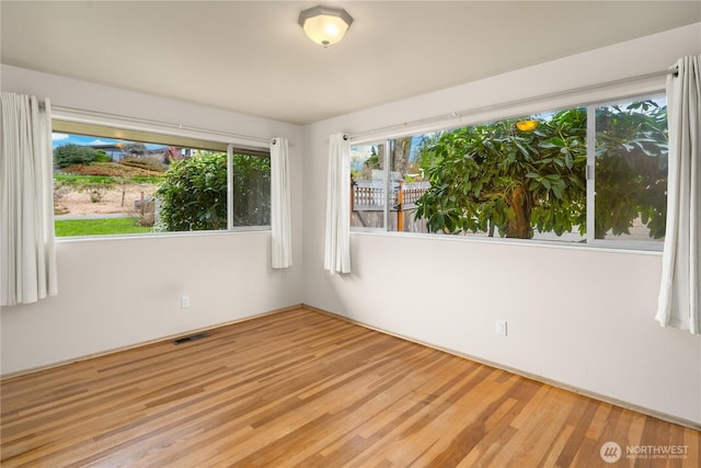 spare room with visible vents and wood finished floors