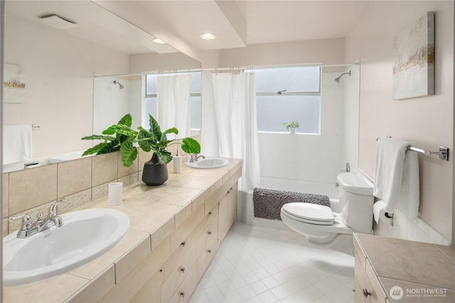 bathroom featuring a sink, shower / bathtub combination with curtain, toilet, and double vanity