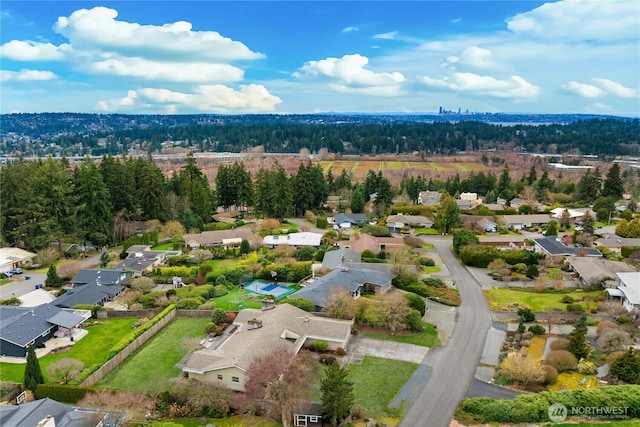 birds eye view of property with a residential view and a forest view