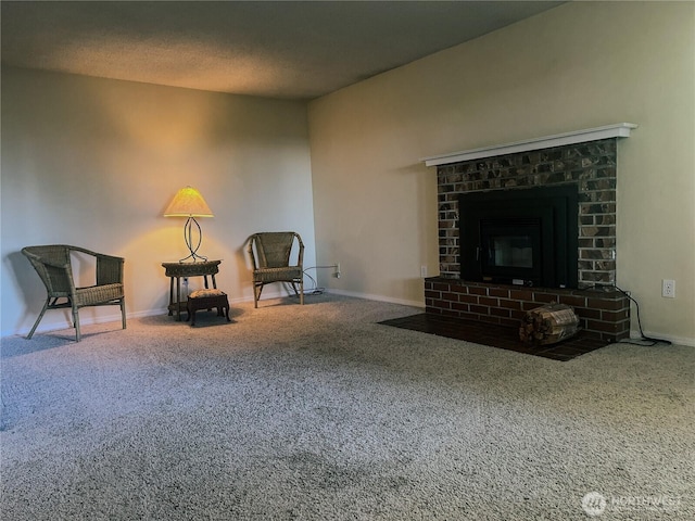 living area featuring baseboards, carpet, a fireplace, and a textured ceiling