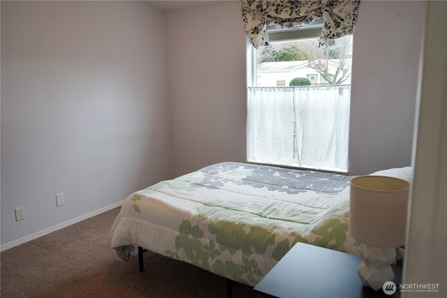 bedroom featuring carpet and baseboards