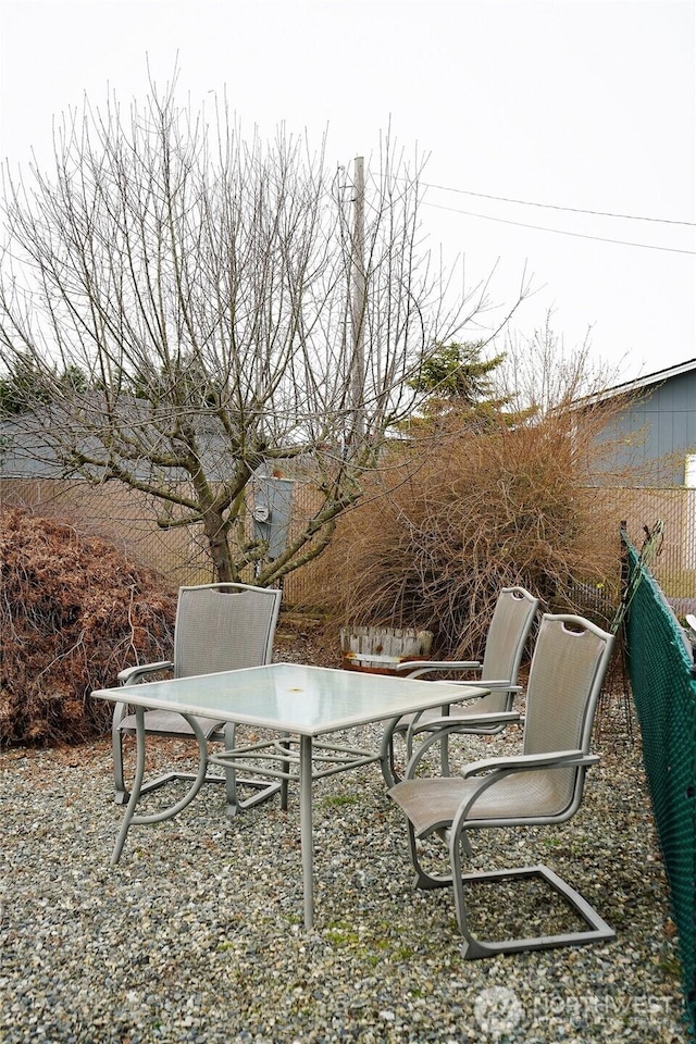 view of patio with outdoor dining space and fence