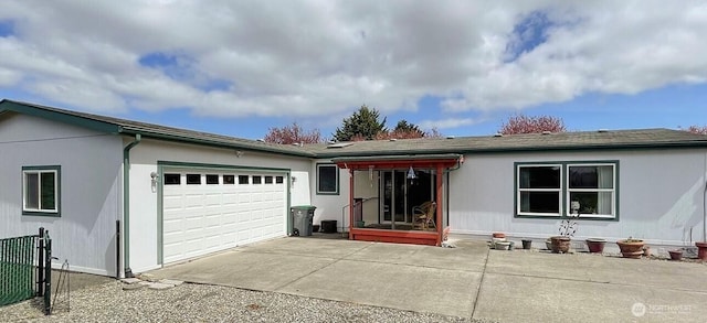 ranch-style house with concrete driveway and an attached garage