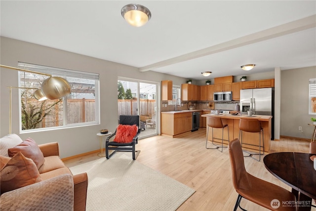 living room featuring light wood-style floors and baseboards