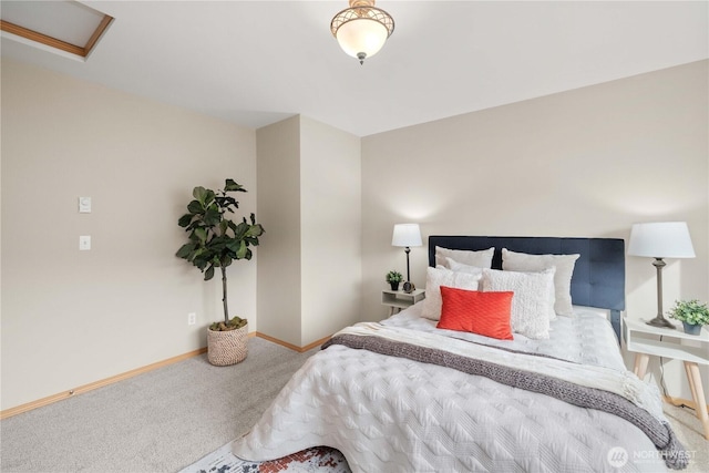 carpeted bedroom featuring baseboards and attic access