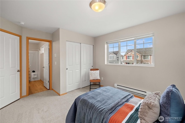 carpeted bedroom with a closet, baseboards, and a baseboard radiator