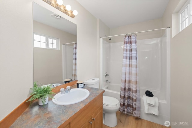 full bath with toilet, wood finished floors, vanity, and shower / bath combination with curtain