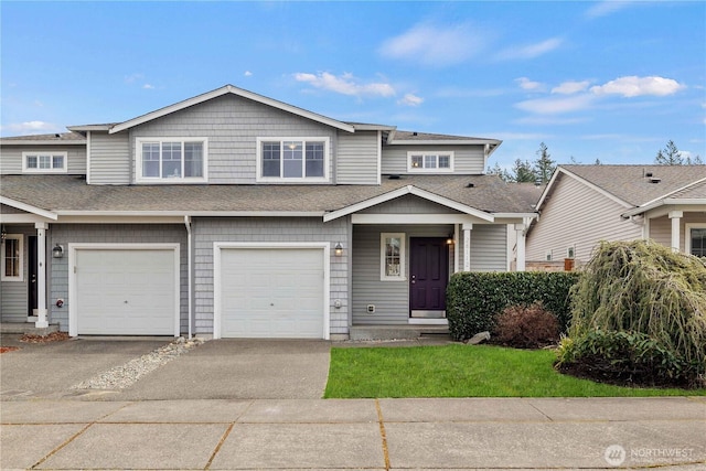 view of front of home with a garage, roof with shingles, and driveway