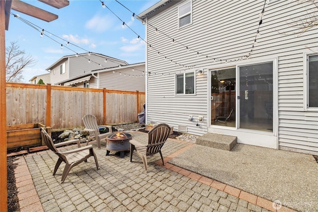 view of patio / terrace with an outdoor fire pit and fence