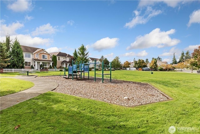 view of property's community featuring a residential view, playground community, and a yard